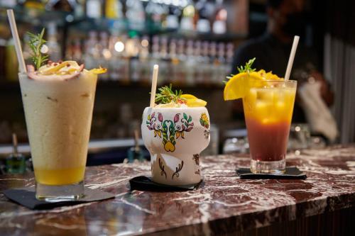three drinks sitting on a table in a bar at DINA MORGABINE SAINT DENIS in Saint-Denis