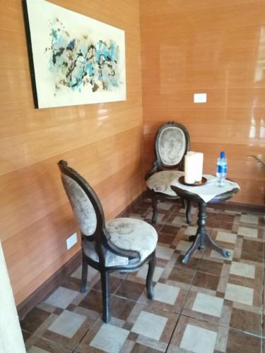 a room with two chairs and a table with a candle at Suite y Loft Casa Toría in San Isidro