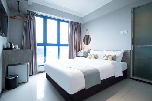 Ένα ή περισσότερα κρεβάτια σε δωμάτιο στο Harbour Ville Hotel