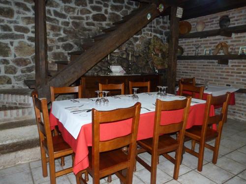 a dining room table with a red and white table cloth at Hotel Rural Los Texos in La Riera