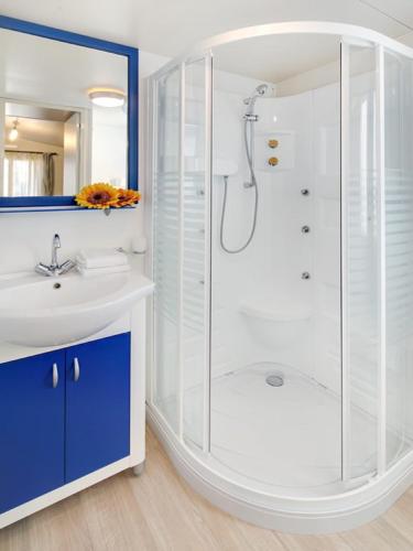 a bathroom with a shower and a sink at Camping Village Pino Mare in Lignano Sabbiadoro