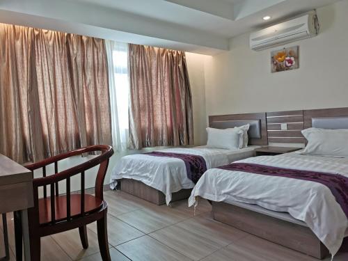 Posteľ alebo postele v izbe v ubytovaní Melang Inn
