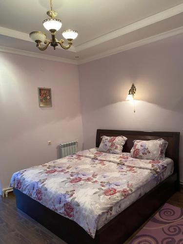 a bedroom with a bed and a chandelier at Christy Hotel in Goris
