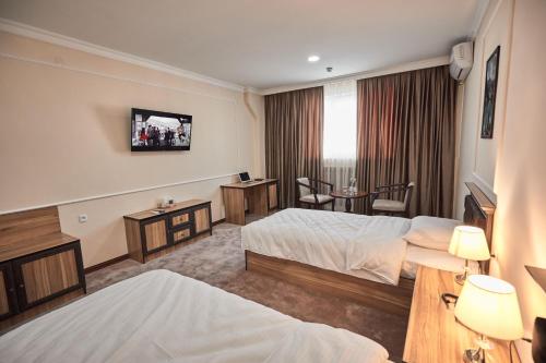 Ліжко або ліжка в номері BAL Tabassum Hotel