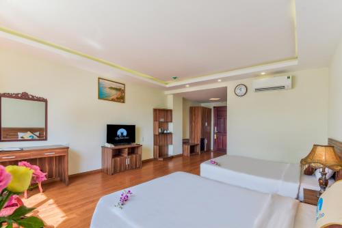 a large room with a bed and a tv at Sky Beach D20 Nha Trang in Nha Trang