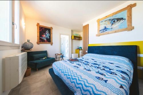 a bedroom with a bed with a blue comforter at Mare e marmellata in Ravenna
