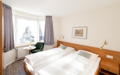 מיטה או מיטות בחדר ב-Haus Wattenblick