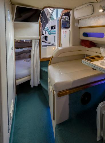 a small room with a bed and a table in it at SLEEPBOAT Barco Hotel Oporto Douro in Porto