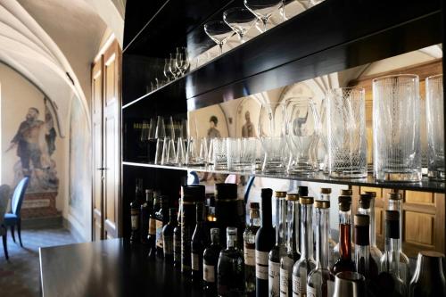 a bar with bottles of wine and glasses on the wall at Castel Maurn in San Lorenzo di Sebato