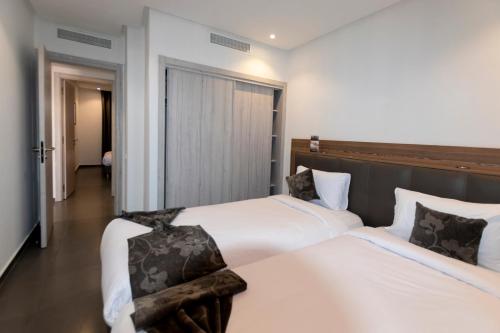 Voodi või voodid majutusasutuse Wazo Appart-Hôtel toas