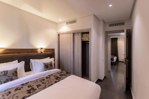 Voodi või voodid majutusasutuse Wazo Appart-Hôtel toas