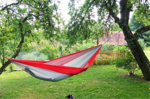 a red and white hammock hanging from a tree at Altes Gehöft am Lormanberg in Kirchberg an der Raab