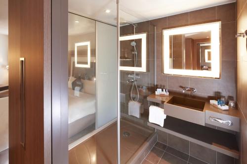 a bathroom with a sink and a shower at Novotel London Brentford in Brentford