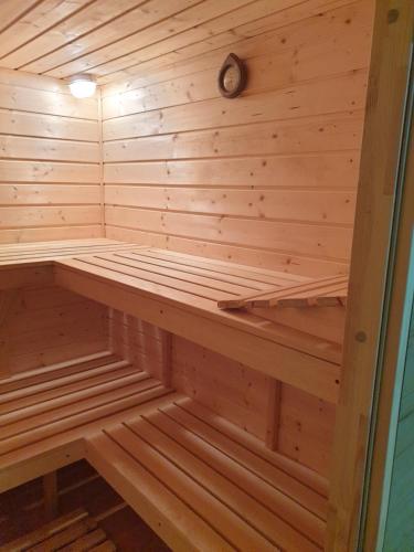 a wooden sauna with a bench in it at Domek w Górach in Lubawka