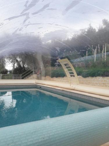 a swimming pool with a slide and a swimming pool at Chalet de charme tout confort in Les Adrets de l'Esterel