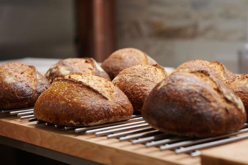 a group of loaves of bread on a cooling rack at Hotel Pod Różą in Kraków