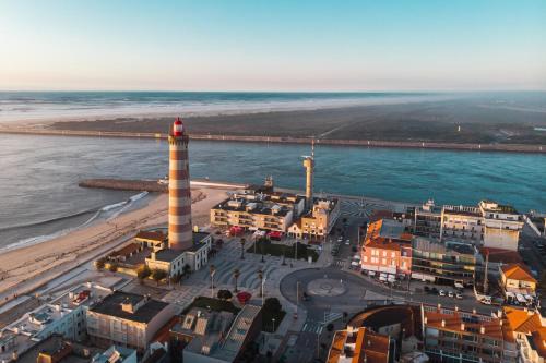 an aerial view of a lighthouse on the beach at Hotel Farol in Praia da Barra