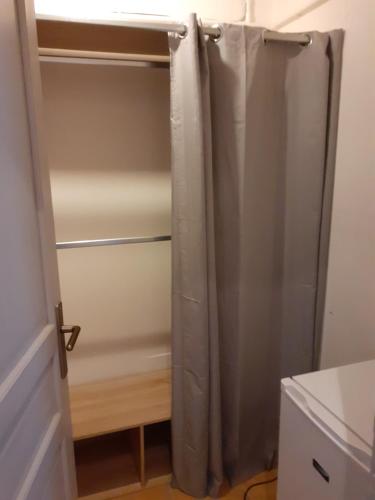 a closet with a shower curtain in a room at frederique lavande bleue in Le Luc