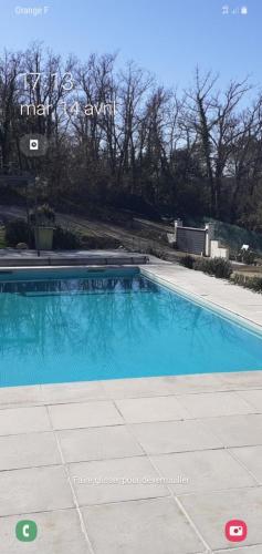 a large blue swimming pool in a yard at frederique lavande bleue in Le Luc