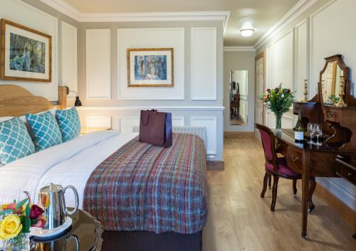 a hotel room with a bed and a desk at Earls Court House in Killarney