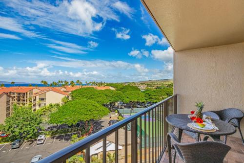 a balcony with a table and chairs and a view at Kaanapali Shores Studio #742 in Lahaina