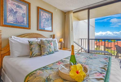 a bedroom with a bed with a view of the ocean at Kaanapali Shores Studio #742 in Lahaina