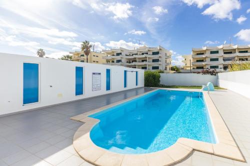 a swimming pool on the roof of a building at Golden Maré BY ALGARVEMANTA in Manta Rota