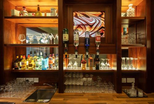 a bar with a bunch of bottles and glasses at Earls Court House in Killarney