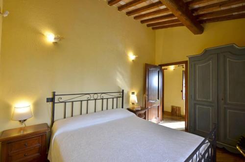 a bedroom with a large bed and a wooden cabinet at Il Mandorlo in Orvieto