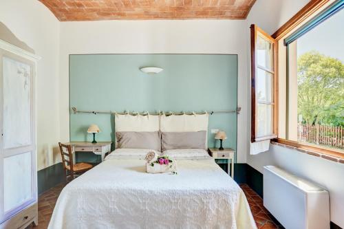 a bedroom with a large bed with a white bedspread at Agriturismo Lunadoro in Monticchiello