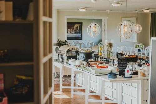 a kitchen with a counter with food on it at Bjäre Golfklubb Hotel & Lodge in Båstad