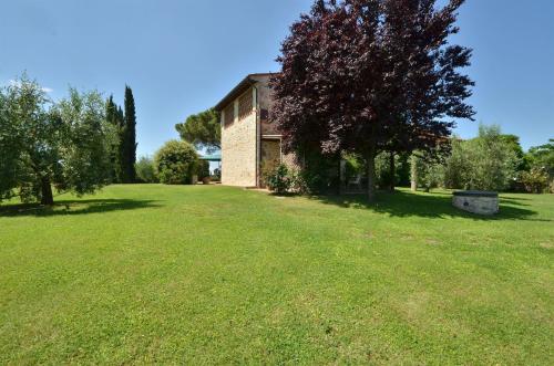 an old brick building in a grassy field at La Capannina in Le Grazie