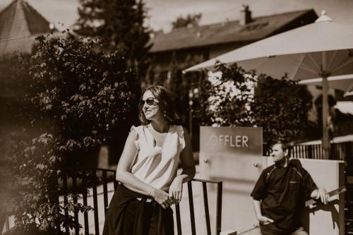 a woman standing next to a fence next to a man at Der Löffler am Semmering in Semmering