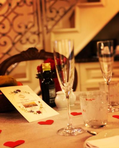 a table with two wine glasses on top of it at Relais Colle San Pietro in Verona