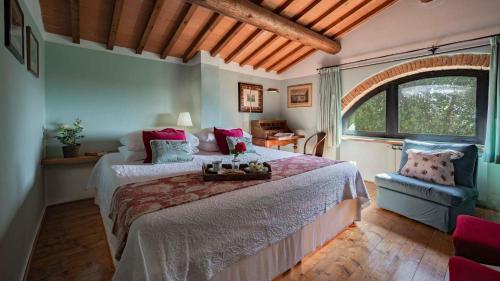 a bedroom with a large bed and a window at Salve Regina in Impruneta