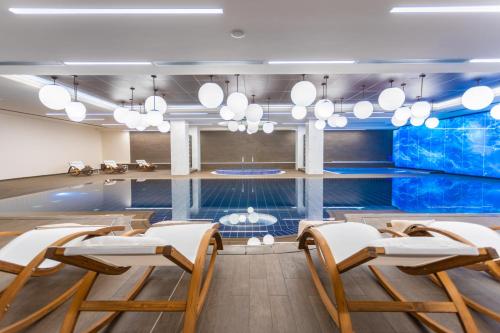 a conference room with chairs and a swimming pool at Hotel Bulgaria in Burgas City