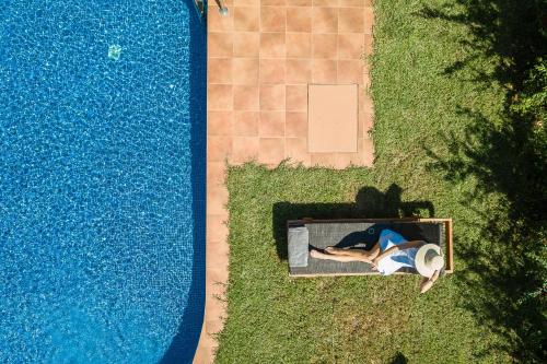 an overhead view of a person laying next to a swimming pool at Physis Villas Chania in Ayiá