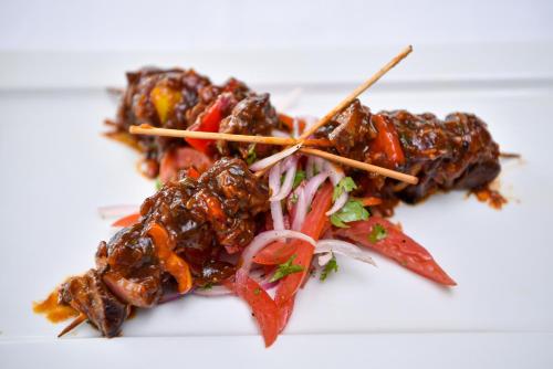 a pile of food on a white plate at Nairobi Safari Club by Swiss-Belhotel in Nairobi