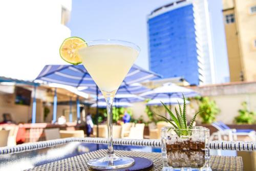 a drink sitting on top of a table with a drink at Nairobi Safari Club by Swiss-Belhotel in Nairobi