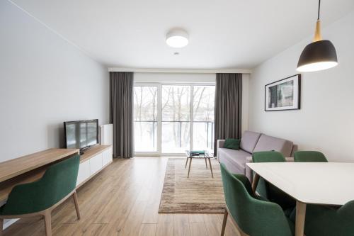 a living room with a couch and a table at Marina Apartments ZOO in Wrocław