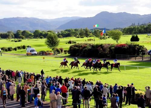 a crowd of people watching horses racing on a field at Rowan House Holiday Home by Trident Holiday Homes in Curranes