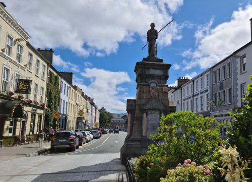 a statue of a man with a sword on a street at Rowan House Holiday Home by Trident Holiday Homes in Curranes
