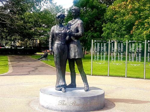 a statue of a woman and a man in a park at Rowan House Holiday Home by Trident Holiday Homes in Curranes