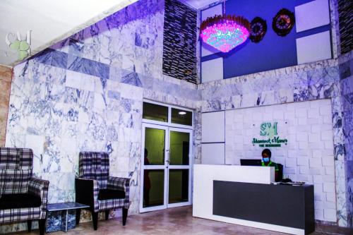 a lobby of a salon with a person sitting at a desk at Shamrockmanor(TheResidence) in Benin City