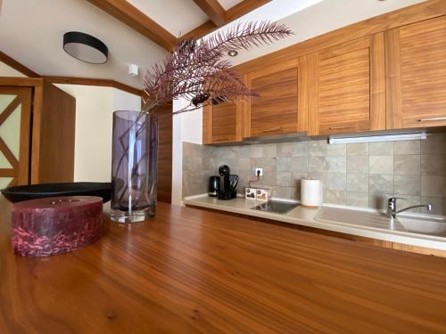 a kitchen with a vase on a wooden counter top at LUX apartman B432 Aparthotel Vučko Jahorina - private host in Jahorina
