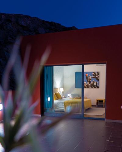 a hotel room with a bed and a glass window at Salobre Golf Villa 3 Premium in Salobre