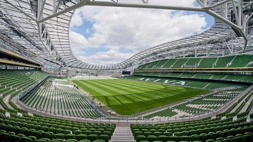 an empty stadium with green seats and a soccer field at Travelodge PLUS Dublin City Centre in Dublin