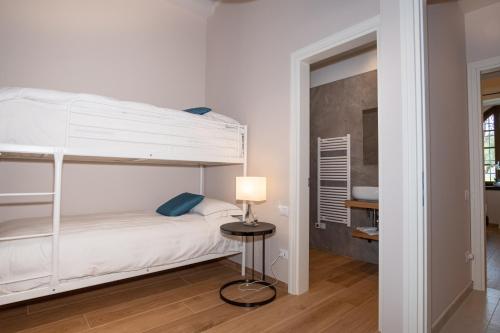 a bedroom with a bunk bed and a table with a lamp at Borgo di Drugolo in Lonato del Garda
