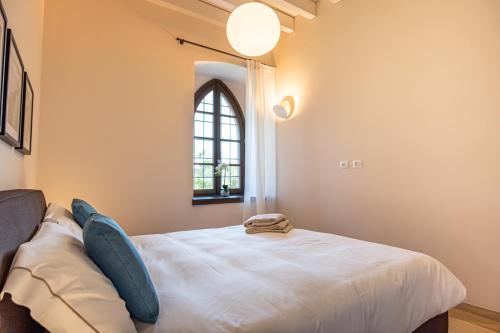 a bedroom with a bed and a window at Borgo di Drugolo in Lonato del Garda
