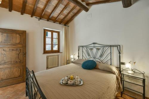 a bedroom with a bed with a tray of food on it at Treccianino 12 in Sovicille
